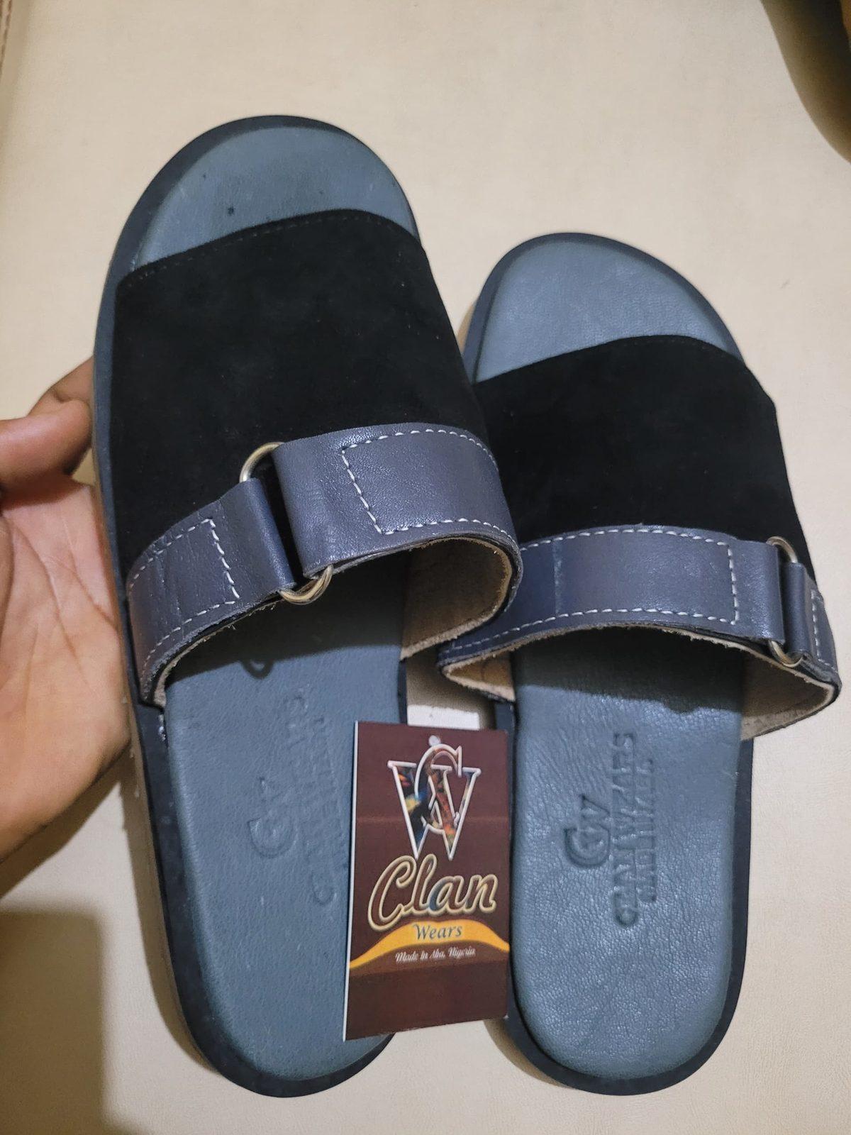 Black suede slides with a buckle strap