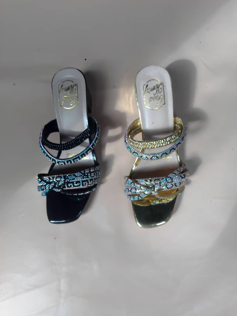 Stone-strap heels in black and gold